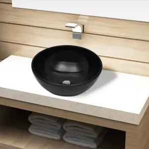 Chiuvetă ceramică pentru baie, rotundă, neagră - Această chiuvetă, realizată din ceramică de cea mai bună calitate, va aduce un plus de stil oricărei băi, toalete sau budoar. Finisajul său lucios ada...